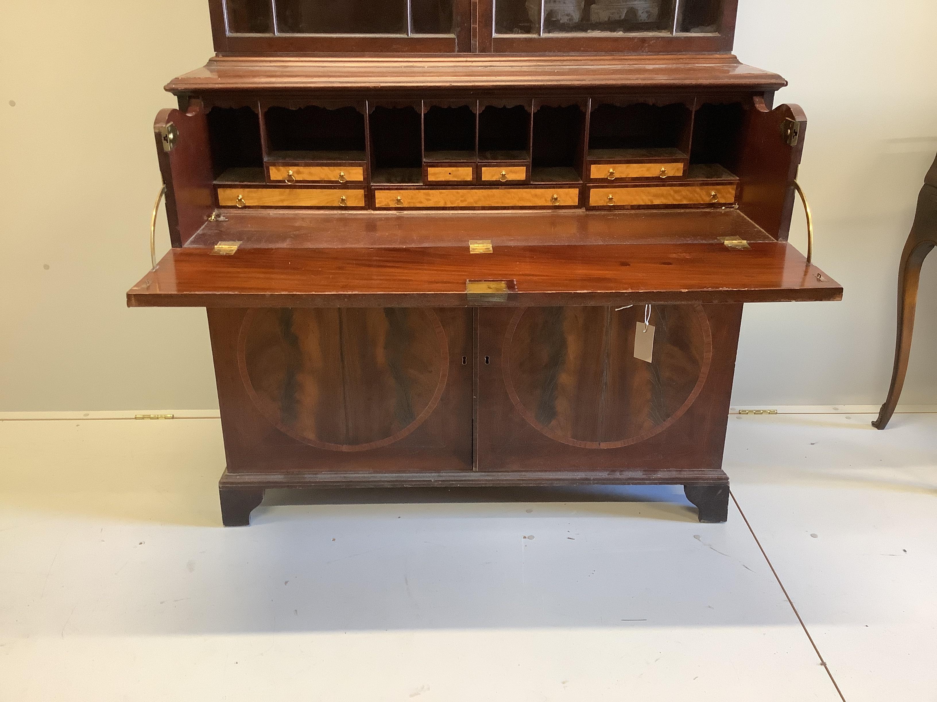 A George III satinwood banded mahogany secretaire bookcase, width 117cm, depth 58cm, height 236cm (a.f.)